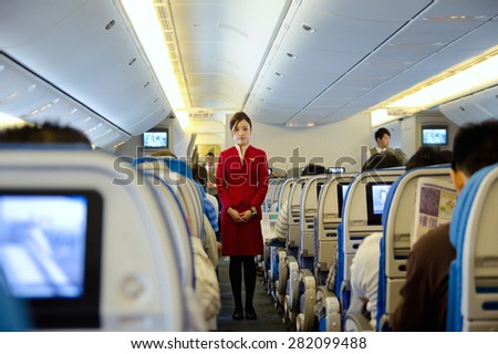 HO CHI MINH CITY, VIETNAM - MARCH 8: Unidentified stewardess of Cathay Pacific Airways gives preflight instructions at the flight to Hong Kong, March 8, 2013, Ho Chi Minh City, Vietnam.