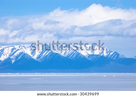 blue mountains under clouds at winter Baikal
