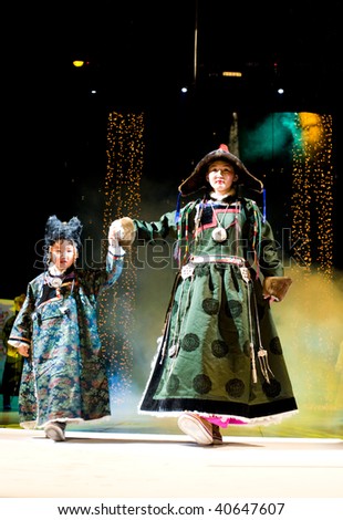 ULAN-UDE, RUSSIA - OCTOBER 29: Asian female model with girl demonstrates dress ethnic (buryat) style festival asian fashion designers October, 29, 2009 Ulan-Ude, Buryatia, Russia