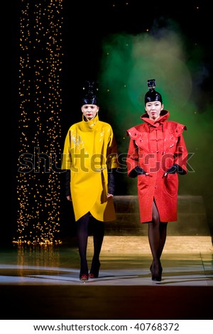 ULAN-UDE, RUSSIA - OCTOBER 29: Two models demonstrate coats in ethnic style at the international asian fashion festival on October, 29, 2009 in Ulan-Ude, Buryatia, Russia.