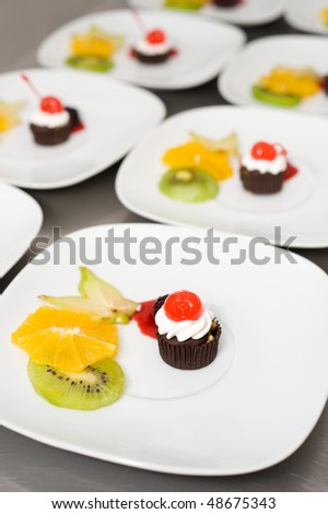 dessert on plates in restaurant kitchen ready for serving up