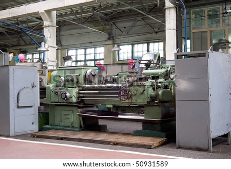 a vintage turning machine at a factory floor