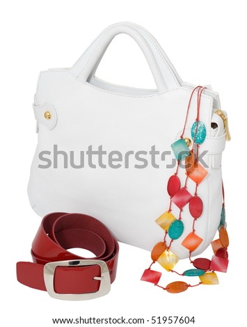 a white ladies handbag with a red belt and a coloured necklace, isolated on white, clipping path