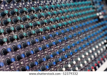 an audio mixing console shot in shallow DOF