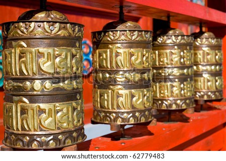 line of buddhist praying drums (written prayers are rolled inside - believers pray rotating drums)