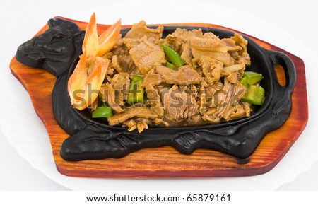 Chinese food. Stewed pork with vegetables, in a cast iron pan.