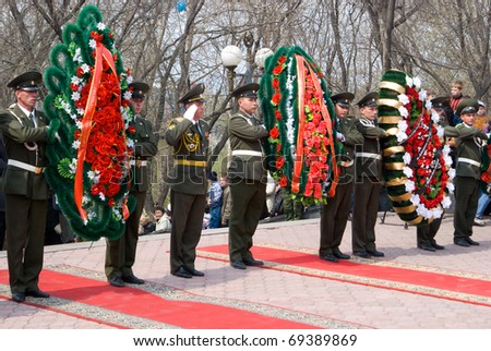 ULAN-UDE, RUSSIA - MAY 9: Guard of Honor lay wreaths to the fallen during WWII memorial on annual Victory Day, on May, 9, 2009 in Ulan-Ude, Buryatia, Russia.