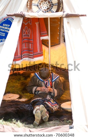 ULAN-UDE, RUSSIA - JULY 17: The 4th General Session of the World Mongolians Convention. A young evenk sits in a tent, July 17, 2010 in Ulan-Ude, Buryatia, Russia.