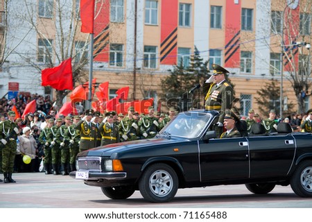 ULAN-UDE, RUSSIA - MAY 9: The commander standing in a car salute to officers - participants of the parade on annual Victory Day, May, 9, 2010 in Ulan-Ude, Buryatia, Russia.