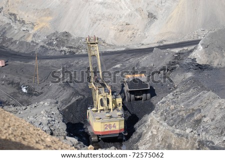 TUGNUI, RUSSIA - APRIL 2: The opening of Tugnuiskaya coal-preparation plant.  A mining shovel puts coal into a hauler, April, 2, 2008 in Tugnui, Buryatia, Russia.
