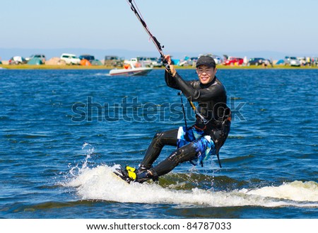 a kitesurfer moves on water on a sunny summer day