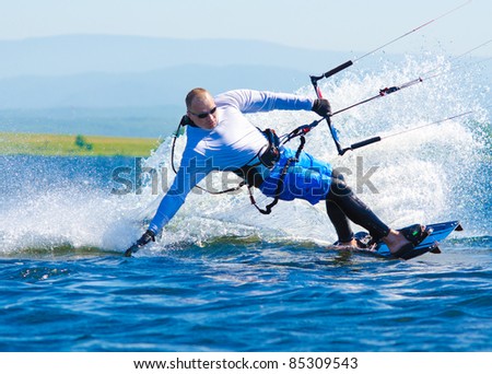 a kitesurfer moves on water on a sunny summer day