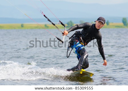 a kitesurfer moves on water on a summer day
