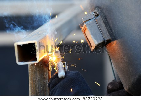 a welder in a safety mask welds