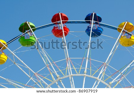 a ferris wheel in blue sky - horizontal shot, copy space