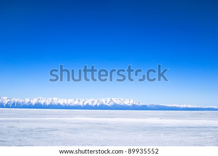 frozen winter Baikal, far mountains in background