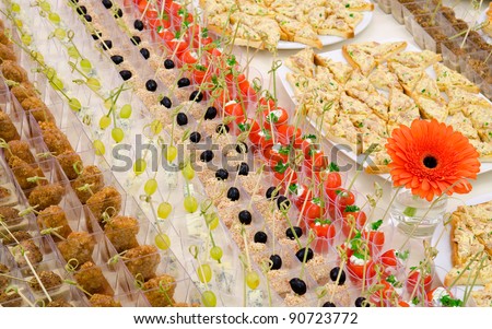 a lot of cold snacks and drinks on buffet table, catering
