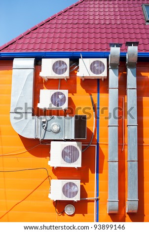 ventilation tubes and some air conditioners on an outer wall