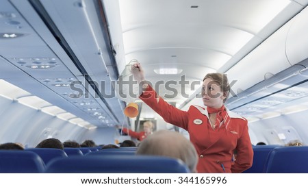 MOSCOW - MAY 28, 2011: Air hostess Yulia of Aeroflot shows how to use an oxygen mask on board. Aeroflot operates the youngest fleet in the world among major airlines, numbering 150 airliners.