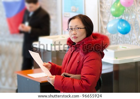 ULAN-UDE, RUSSIA - MARCH 4: A woman holding a ballot for voting at the presidential election of Russian Federation is going to vote on March 4, 2012 at a local polling station.