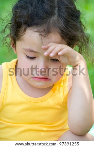 a cute 4 year old girl cries, closeup