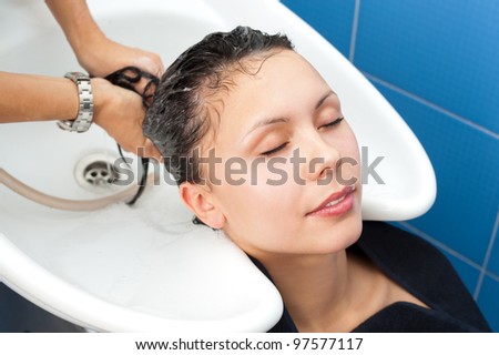 hair washing at a hairdressing salon, young caucasian brunette