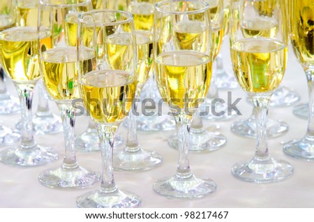 many glasses with champagne on a buffet table, catering