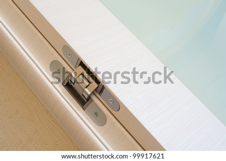 a modern door hinge, a closeup shot