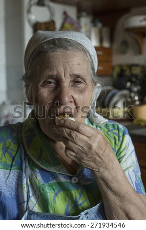 Old woman eating an egg.