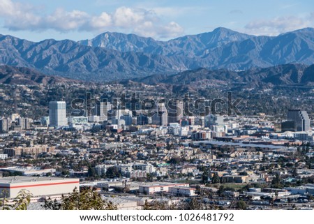 Downtown Glendale with the San Gabriel Mountains in background.  View from hilltop at Griffith Park in Los Angeles California.