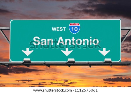 San Antonio Texas route 10 west overhead freeway sign with sunset sky.