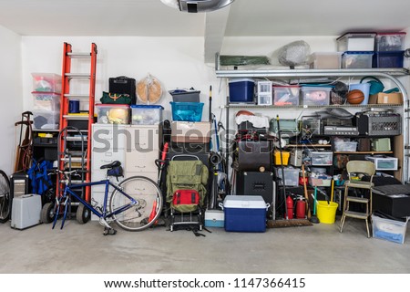 Garage storage shelves with vintage objects and equipment.