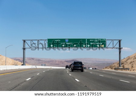Interstate 15 Las Vegas freeway and highway 58 Bakersfield signs in the Mojave desert near Barstow, California.