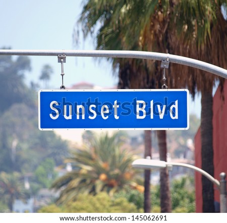 Sunset Blvd Street Sign With Palm Trees In Hollywood, California.