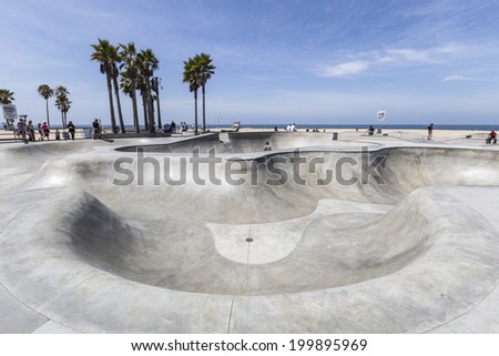 VENICE BEACH, CALIFORNIA - JUNE 21 : Deep concrete ramps and palm trees at the popular public skate board park at Venice Beach on June 21, 2014 in Los Angeles, California.