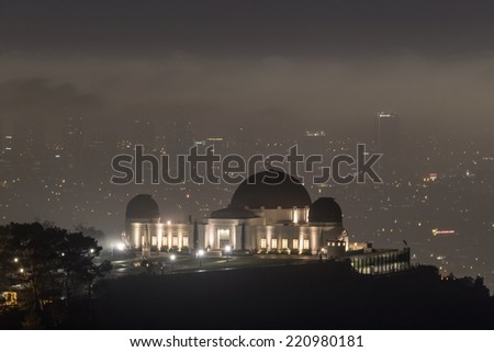 LOS ANGELES, CALIFORNIA - October 1, 2014:  Griffith Park Observatory with fog shrouded downtown Los Angeles behind.