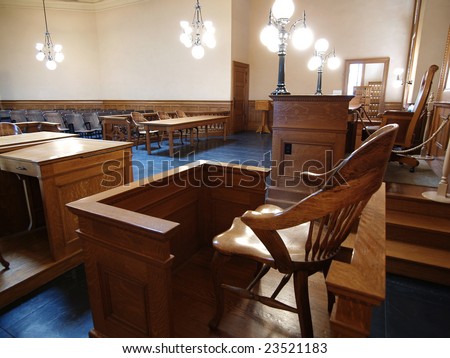 A empty witness chair inside a classic American courtroom.