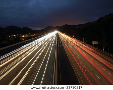 Fast evening traffic on a ten lane California Freeway.