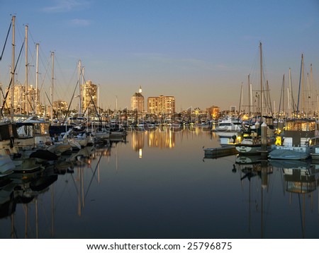 Pleasure boats and apartment towers enjoy a California sunset.