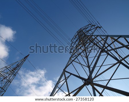 Two electric towers rise into the blue California sky.