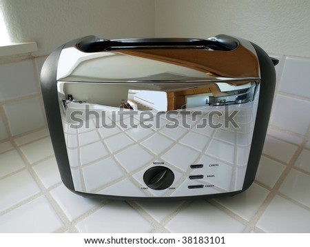 Toaster reflecting a bright, clean condo kitchen.