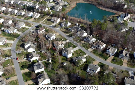 Aerial of uniformly white suburban houses in eastern United States.
