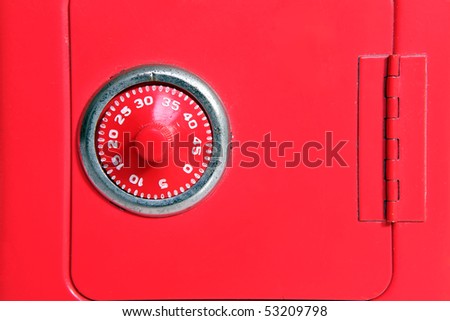 Combination lock on a toy piggy bank safe.