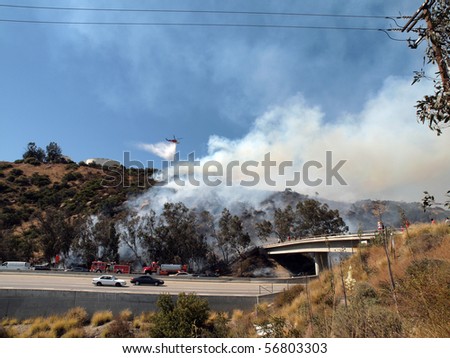 CHATSWORTH CALIFORNIA - JULY 8:  Brush fire burns along the 118 Freeway on July 8, 2010 in Chatsworth, California