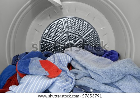 Guy clothes and towels in the dryer.   Fresh, clean and ready to fold.