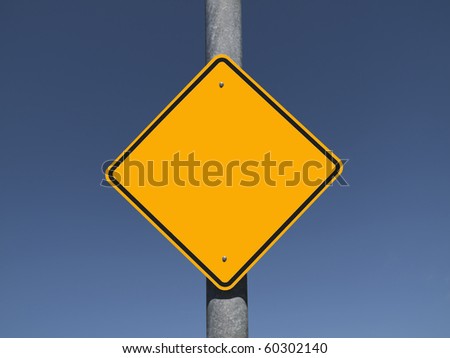 Blank caution sign with a deep blue sky.