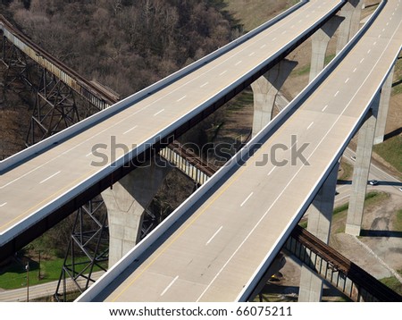 Brand new freeway bridges through forested countryside in the eastern United States.