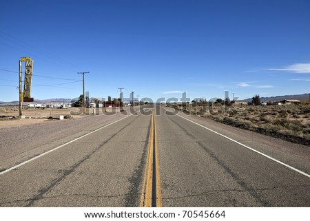 Decayed portion of historic Route 66 in the middle of California\'s vast Mojave desert.