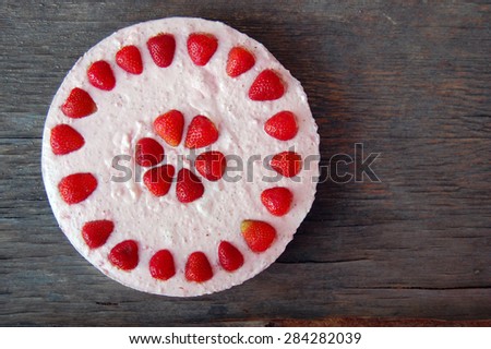 background with raw strawberry cake on rustic wooden table