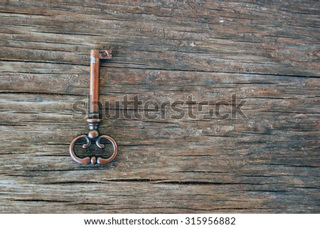 old vintage key on rustic wooden table